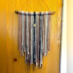 Yarn and things wall hanging on a rustic stick